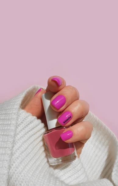 istock female hand beautiful pink manicure sweater 1319659242