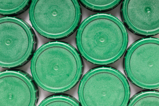 istock Green plastic bottle caps in a row 1319659715