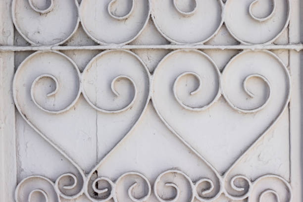 Forged metal pattern painted in white paint, curls look like hearts.