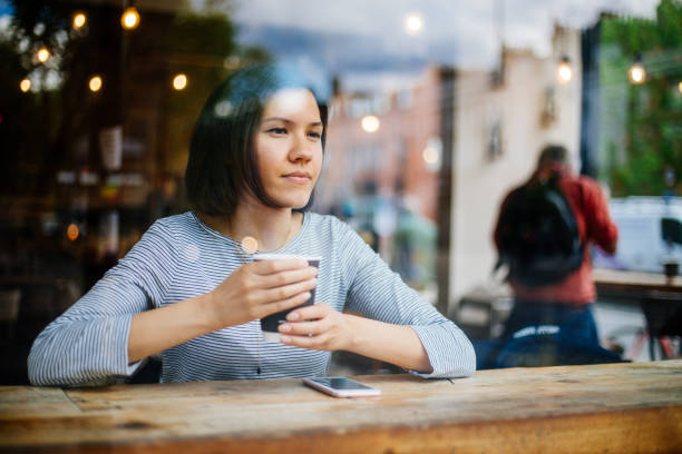 istock Woman relaxing at cafe 1319659862