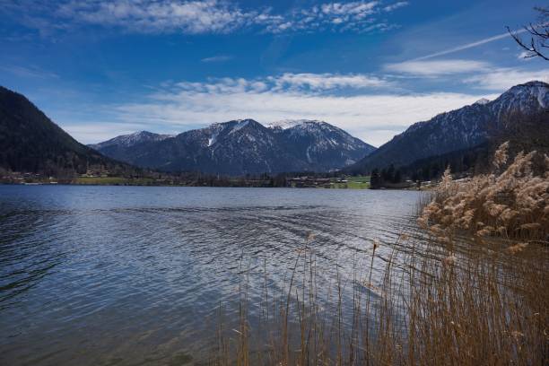 istock Alpine lake with the mountains partially covered by snow. 1319660540