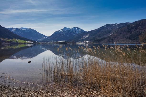 istock Alpine lake with the mountains partially covered by snow. 1319660552
