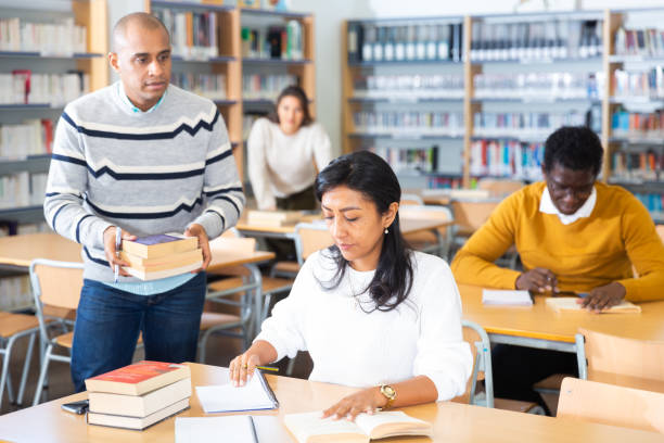 istock Focused adult Latina studying in university library 1319662340