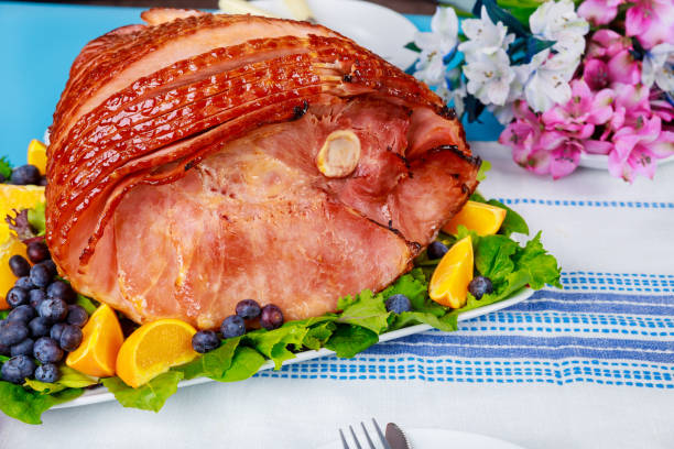 istock Sliced hickory smoked ham with fresh orange and blueberries. 1319662458