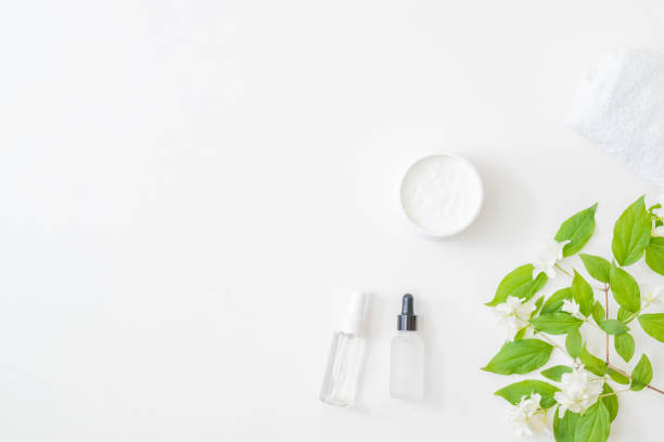 istock Flat lay composition with cosmetics and jasmine flowers on a light background 1319665956