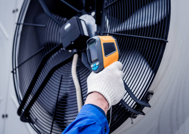 istock Technician uses a thermal imaging infrared thermometer to check the condensing unit heat exchanger. 1319667530