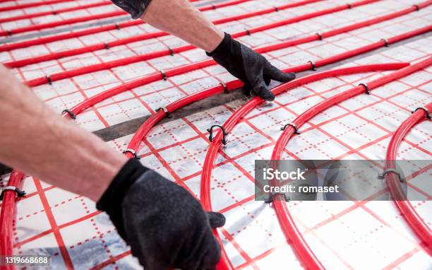 Pipefitter Install System Of Underfloor Heating System At Home Stock Photo - Download Image Now