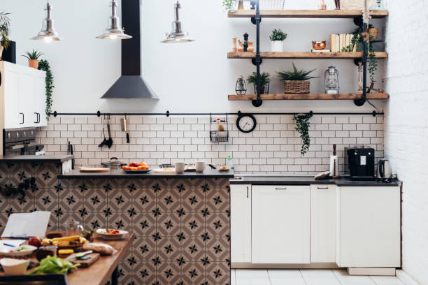 istock Modern new light interior of kitchen with white furniture. 1319668713