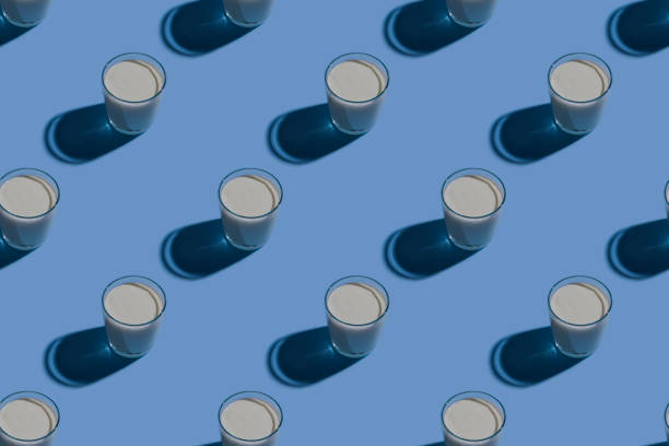 istock World Milk Day. Pattern on a blue background. A glass of milk. Pattern. 1319668862