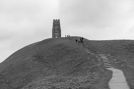 Black and white photo of Galstonbury Tor on the Somerset Levels