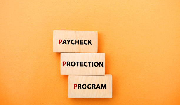 istock Wooden blocks with words Paycheck Protection Program. Loan that helps businesses keep their workforce employed during the COVID-19 crisis. Business and finance concept 1319669759