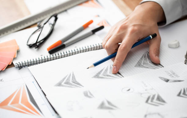 istock Graphic designer drawing sketches logo design. 1319671649