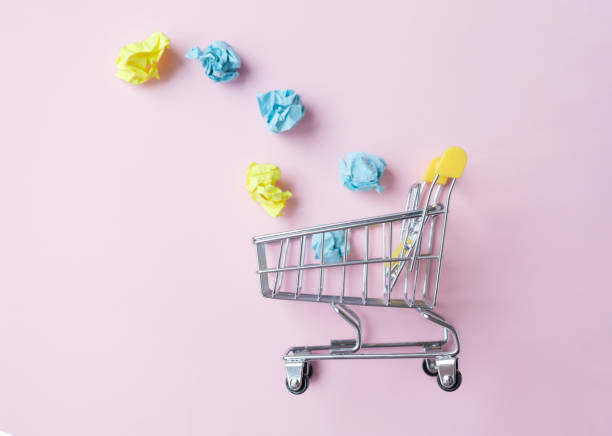 istock Miniature trolley on a pink background, business concept 1319671709