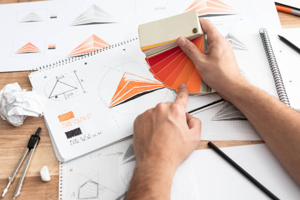 istock Graphic designer drawing sketches logo design. 1319671793