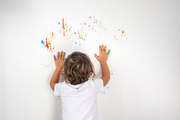 istock Boy Showing Colorful Paint on His Hands 1319673724