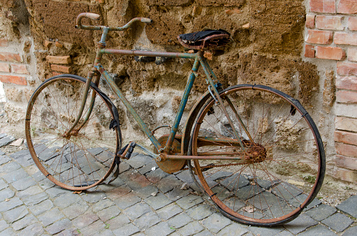 An old bicycle is bolted to the wall.