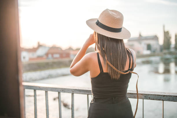 istock Tourist taking photos with camera on vacation 1319680353