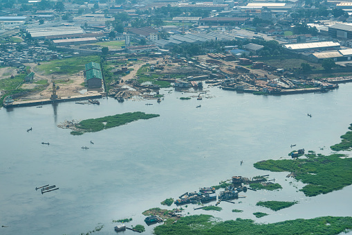 Kinshasa, Democratic Republic of Congo - December 13, 2014:\nAerial view of the river port, docks and simple shipyards on the banks of the Congo River in the outskirts of the Congolese capital Kinshasa. The Congo River is the most important and often the only means of transporting goods and people in the Congo.
