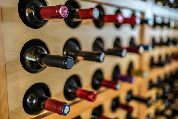 istock Wine bottles on wooden rack in wine cellar 1319683154