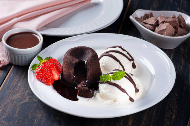 istock Petit Gateau with ice cream and strawberry on white plate 1319683464