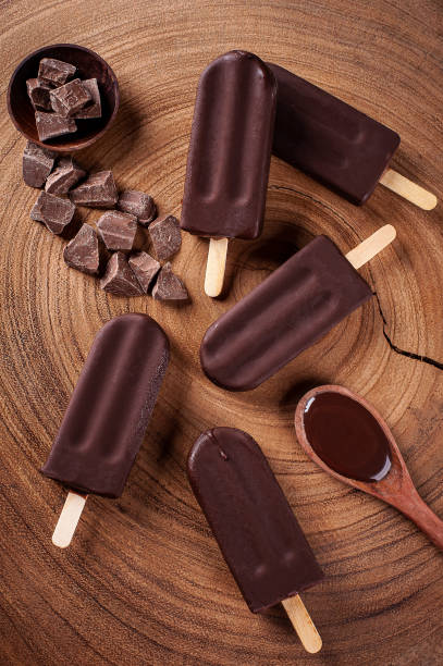 istock Composition with chocolate popsicles on wooden background. Top view 1319683992