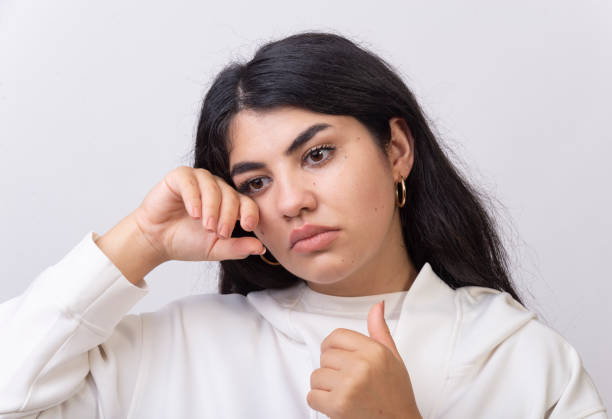 Depressed woman cries on the face of domestic violence. Depressed woman cries on the face of domestic violence. wiping tears stock pictures, royalty-free photos & images