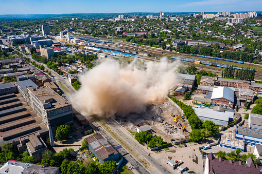 Kharkiv, Ukraine - 23 may 2021: Aerial view of dust cloud after collapsing of old building after demolishing