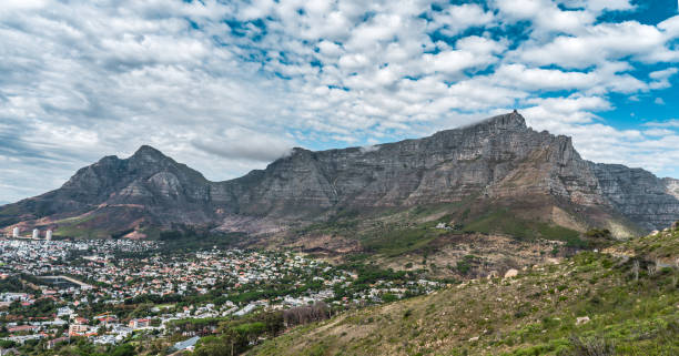 istock Table mountain Panoramic view with Cape Town city bowl in the foreground - White fluffy clouds - Great outdoors adventure and travel holiday destination, Cape Town, South Africa 1319684970