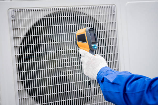 istock Technician uses a thermal imaging infrared thermometer to check the condensing unit heat exchanger. 1319684986