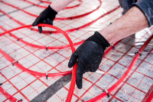 istock Pipefitter install system of underfloor heating system at home 1319685026