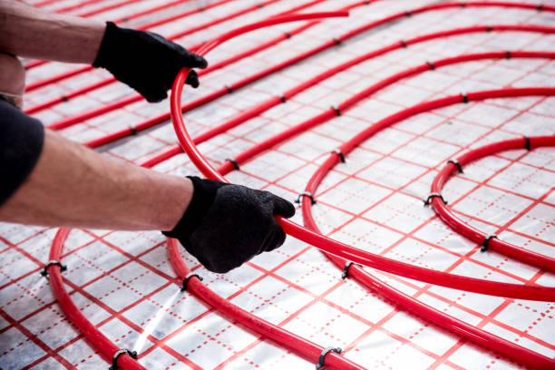 istock Pipefitter install system of underfloor heating system at home 1319686608