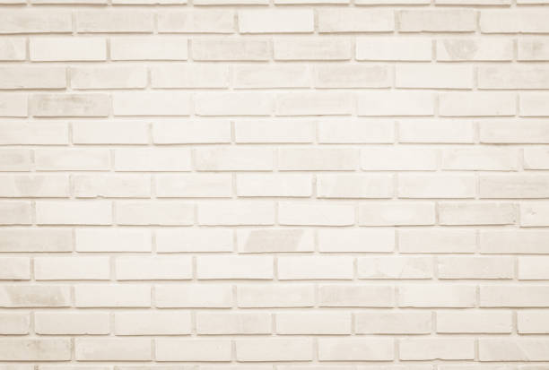 istock Empty Background of wide cream brick wall texture. Old brown brick wall concrete or stone pattern nature, wallpaper limestone abstract floor/Grid uneven interior rock. Home & office design backdrop. 1319689306