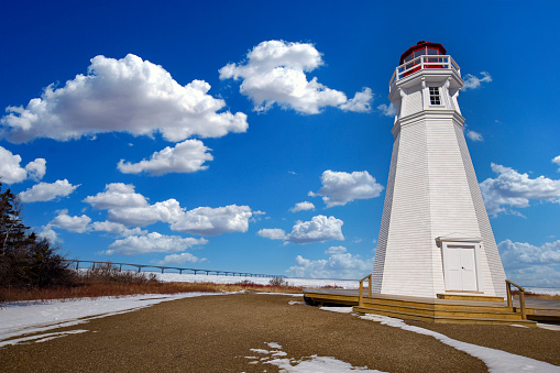Cape jourimain lighthouse in New Brunswick on the border of New Brunswick and Prince Edward Island with Confederation Bridge in the background