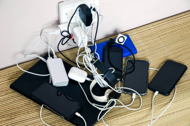istock Sharing power: power adapter and power banks are charging multiple devices in a messy cable connection 1319690279