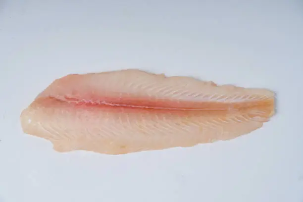 Photo of Fresh fillet dory fish on a white background