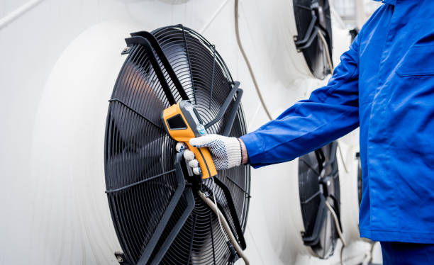 istock Technician uses a thermal imaging infrared thermometer to check the condensing unit heat exchanger. 1319690941