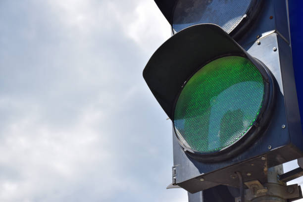 istock On the right side of the frame, there is a traffic light with a glowing green light. There is a place on the left for an inscription 1319690974