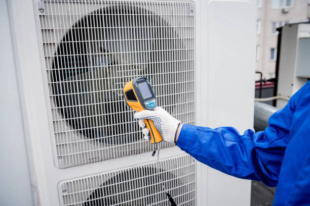 istock Technician uses a thermal imaging infrared thermometer to check the condensing unit heat exchanger. 1319691090