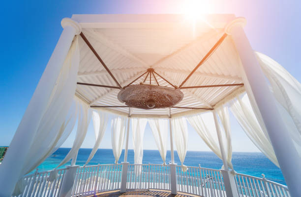 istock Romantic gazebo on the beach with blue sea 1319692114