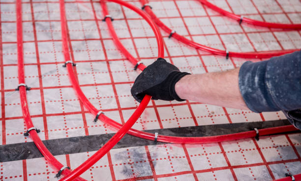 istock Pipefitter install system of underfloor heating system at home 1319692257