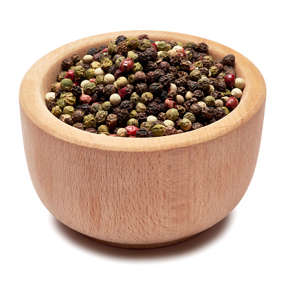 black round pepper spice in wooden bowl or mortar on white background.