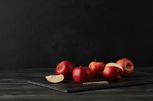 Still Life Background with Apples on Black Slate Cutting Board
