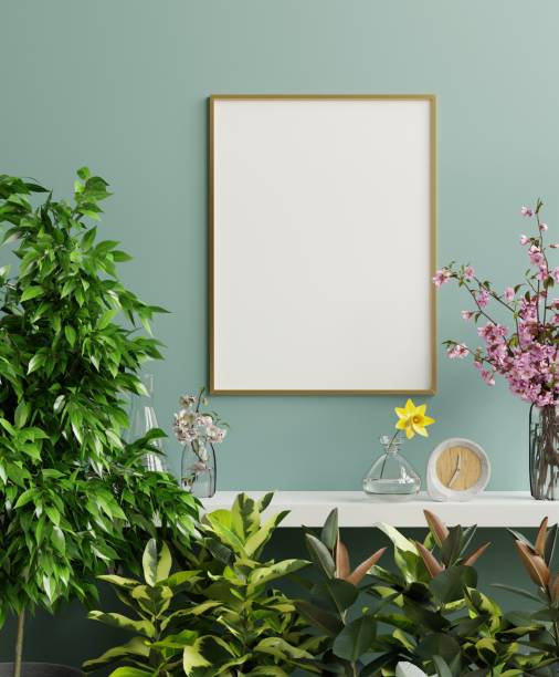 istock Mock up gold photo frame on the white shelf with beautiful plants. 1319701976