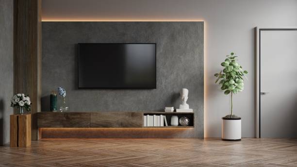 istock Mockup a TV wall mounted in a dark room with concrete wall. 1319702176