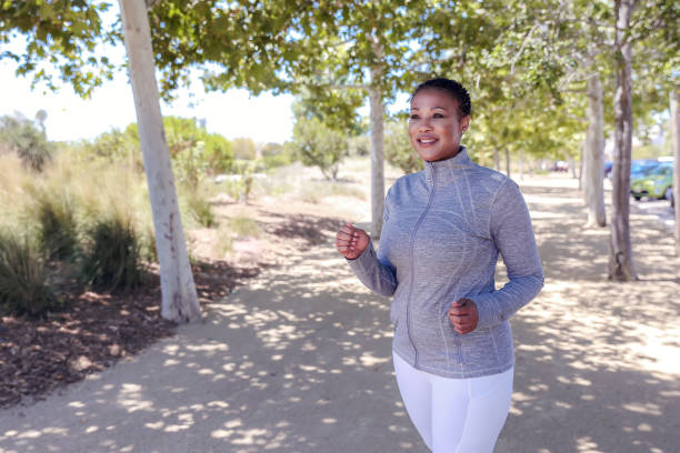 istock Attractive black woman exercising in nature 1319704440