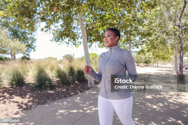 Attractive Black Woman Exercising In Nature Stock Photo - Download Image Now - Racewalking, Walking, Exercising