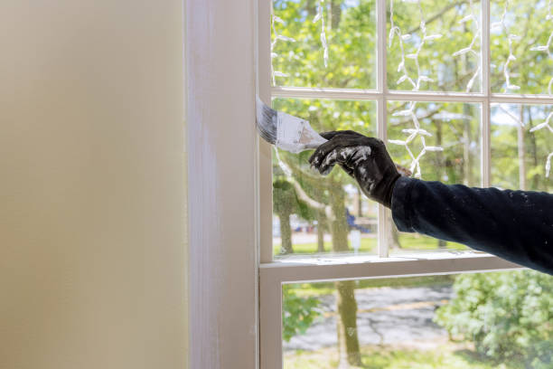 istock Home restoration worker painting using paint brush a window frame trim 1319704699