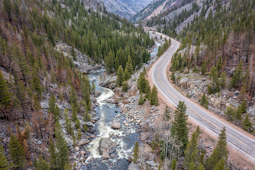 Cache la Poudre River and highway at Poudre Falls - aerial view in spring  with high flow