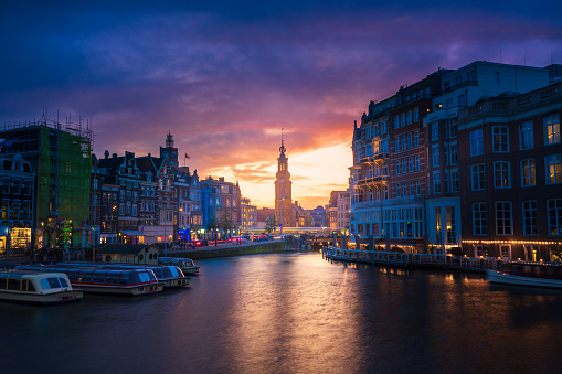 Amsterdam Cityscape with Munttoren Mint Tower and Amstel River with Colorful Sunset, Holland, Netherlands