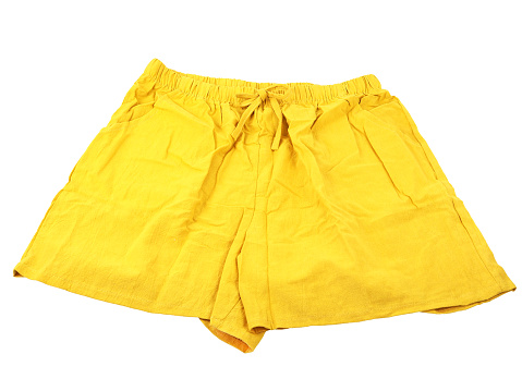 Yellow female cotton linen short pants isolated on a white background.